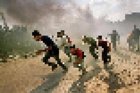 Palestinian youths flee from sniper fire during an Israeli armyincursion in the northern Gaza Strip.